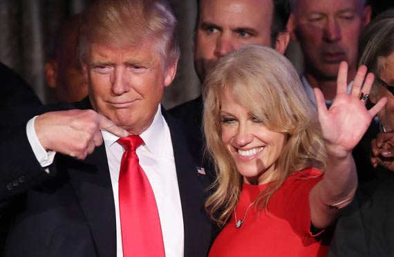 Donald Trump and Kellyanne Conway together at an event. Trump is pointing fingers at her as a symbol of praising.