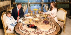 Barron Trump dining with his father Donald and mother Melania in fancy looking table and chair.