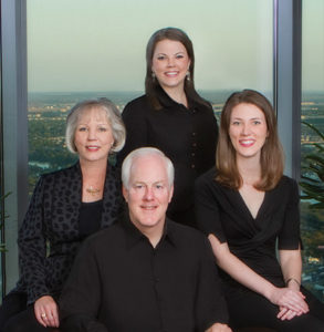 John Corny with his wife and two daughters.