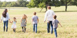 Gaines Family with children walking in their 40 acres farm.