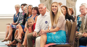 Lara Trump sits in the audience with her father and other family.